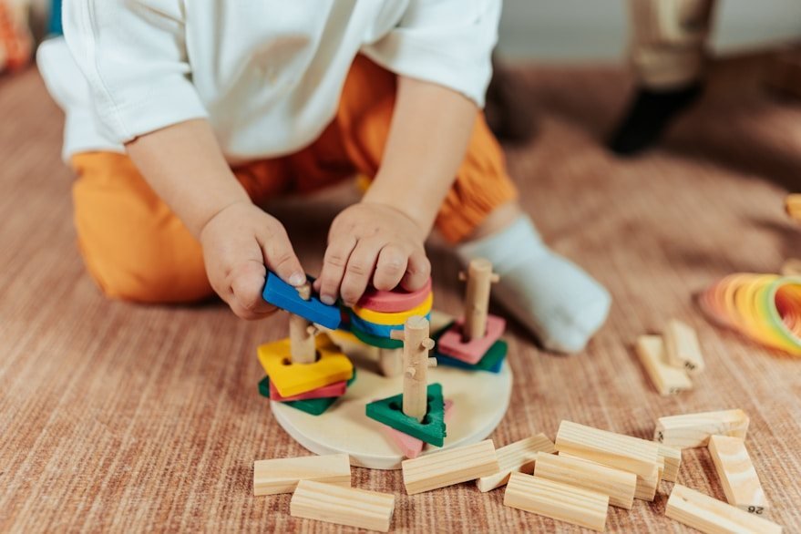A child playing with wooden shape-sorting toys
