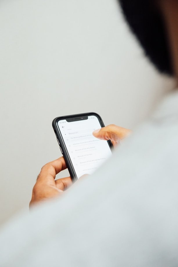 A hand holding a smartphone