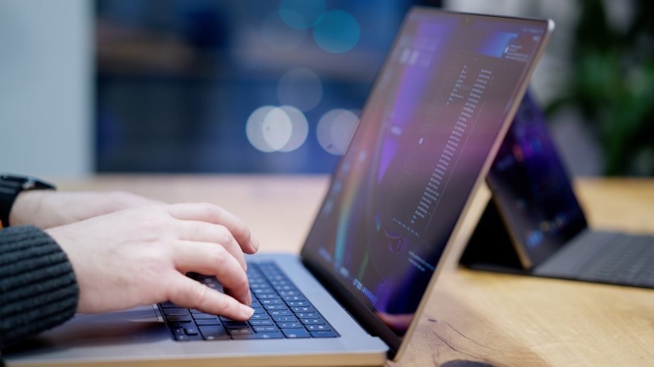 Hands typing on a laptop keyboard